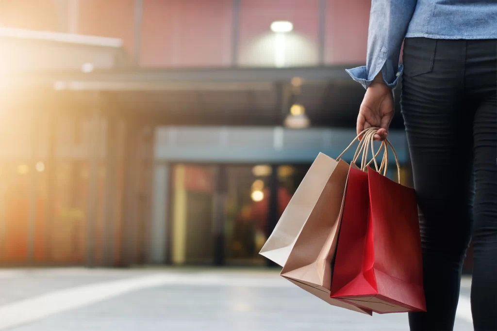 woman walking with shopping bags on shopping mall background