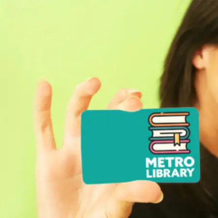 Woman holding library card thumbnail