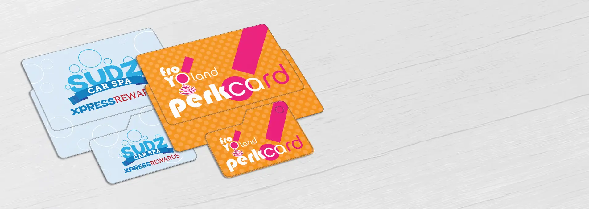 Loyalty cards for a carwash and a frozen yogurt shop, each accompanied by a key tag.