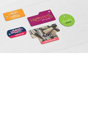 A collection of single Teslin® key tags in various shapes, designed for diverse retail environments including a sporting goods store, dry cleaning service, pet shop, bookstore, and women’s boutique.