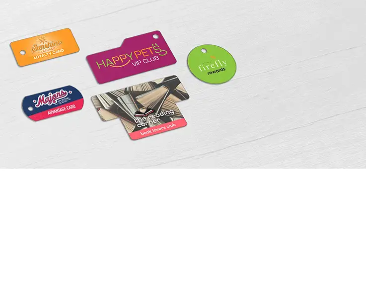 A collection of single Teslin® key tags in various shapes, designed for diverse retail environments including a sporting goods store, dry cleaning service, pet shop, bookstore, and women’s boutique.